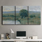Three-panel canvas wall art featuring riverbank landscape with reflections, displayed above a desk in a home office.