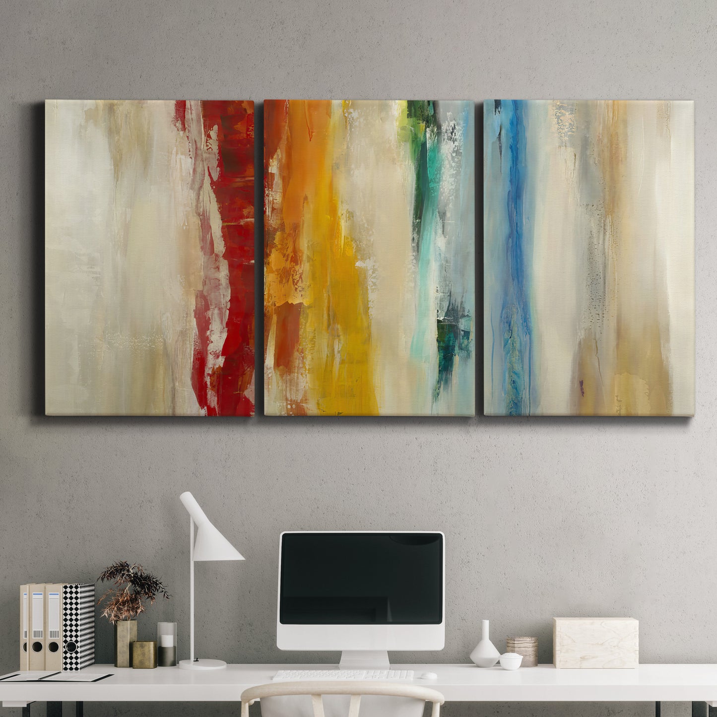 Three-panel canvas wall art featuring abstract divided color hemisphere forms, displayed above a desk in a home office.