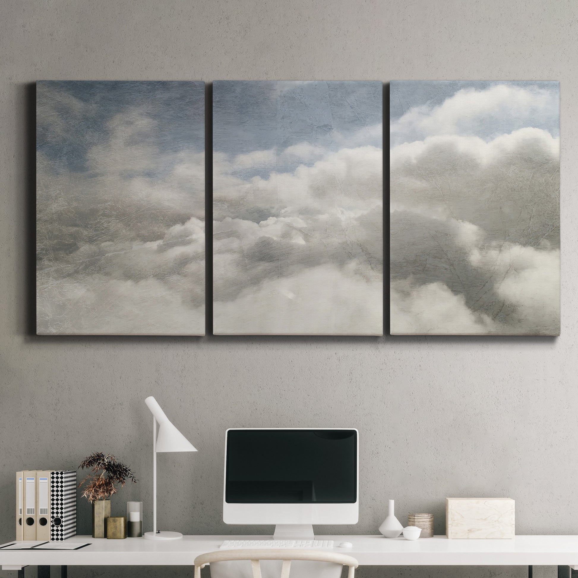Three-panel canvas wall art featuring aerial landscape view photograph, displayed above a desk in a home office.