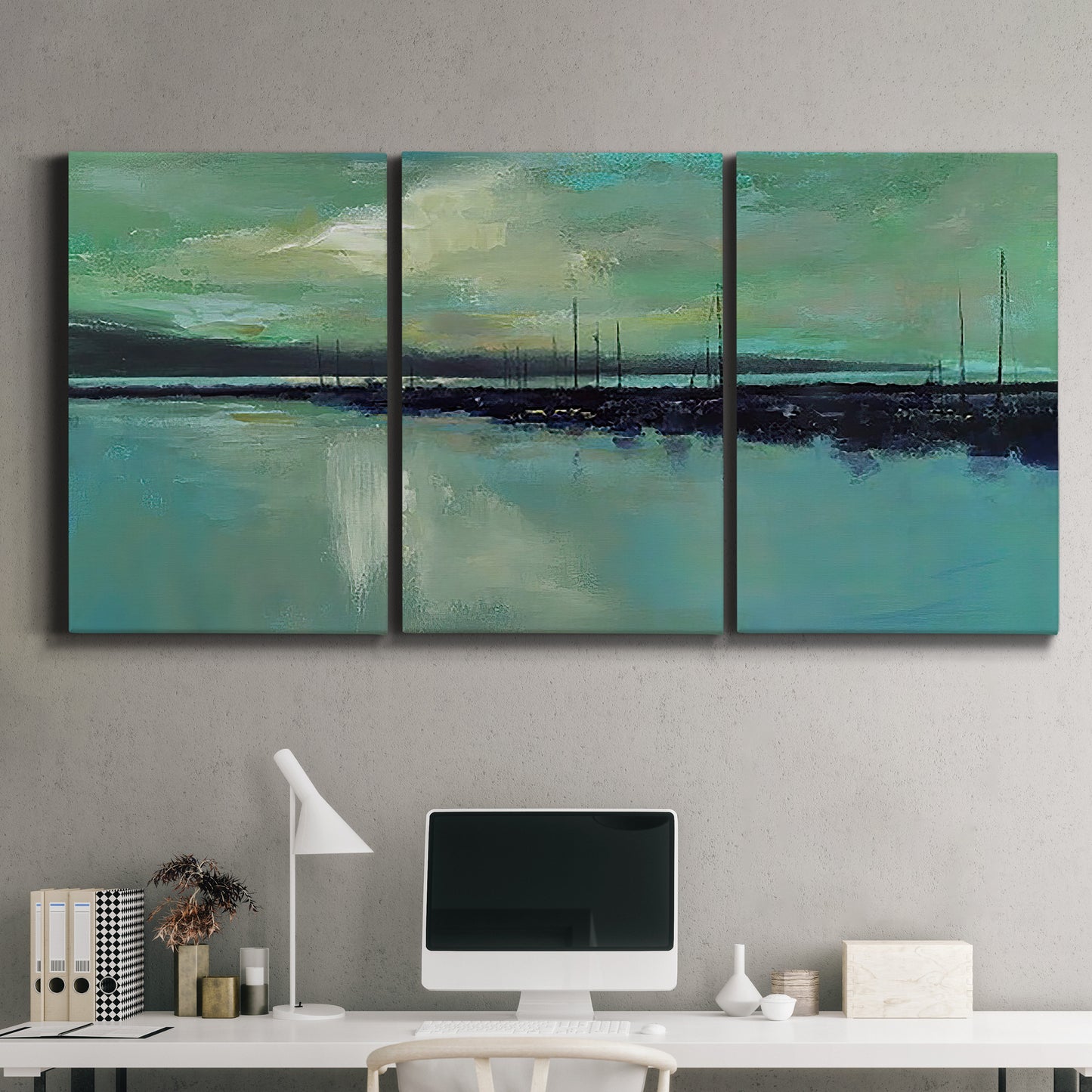 Three-panel canvas wall art featuring calm harbor water with glowing horizon, displayed above a desk in a home office.