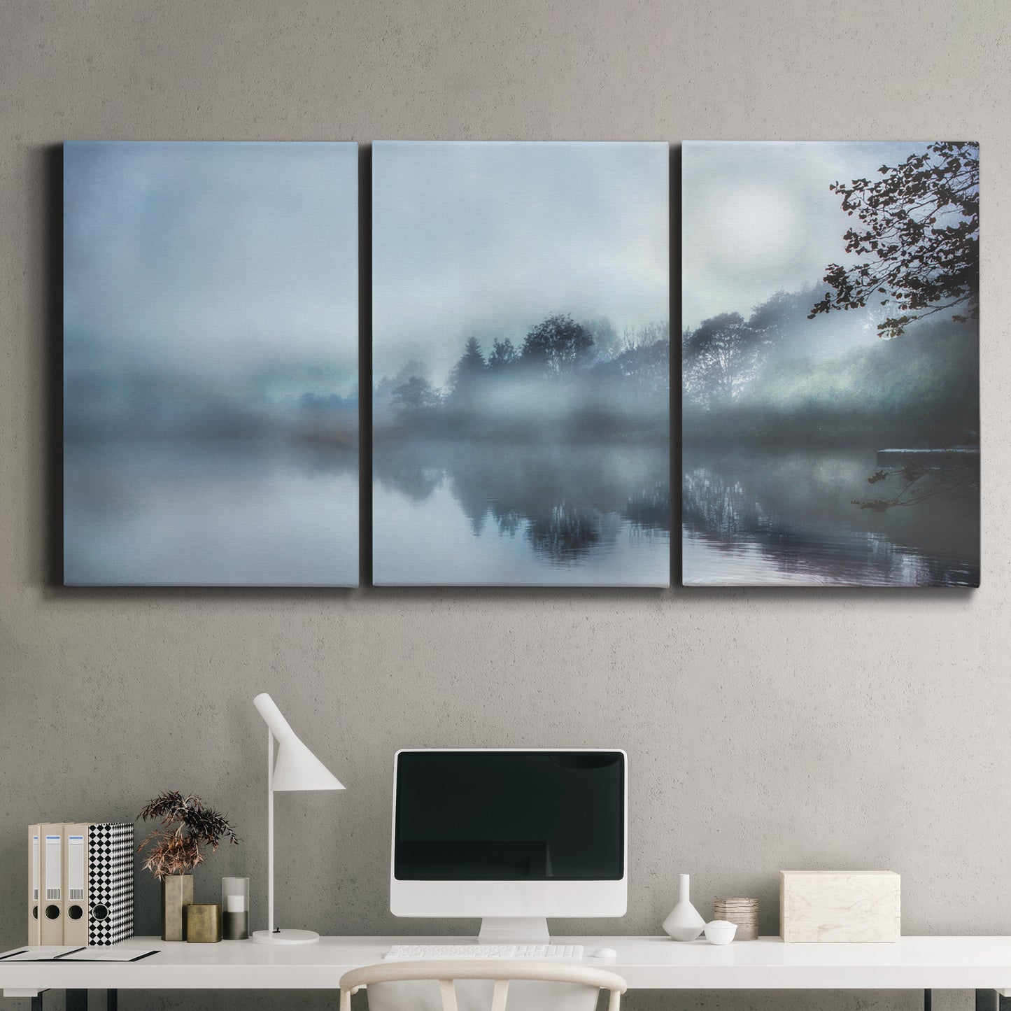 Three-panel canvas wall art featuring calm waters at sunrise photograph, displayed above a desk in a home office.