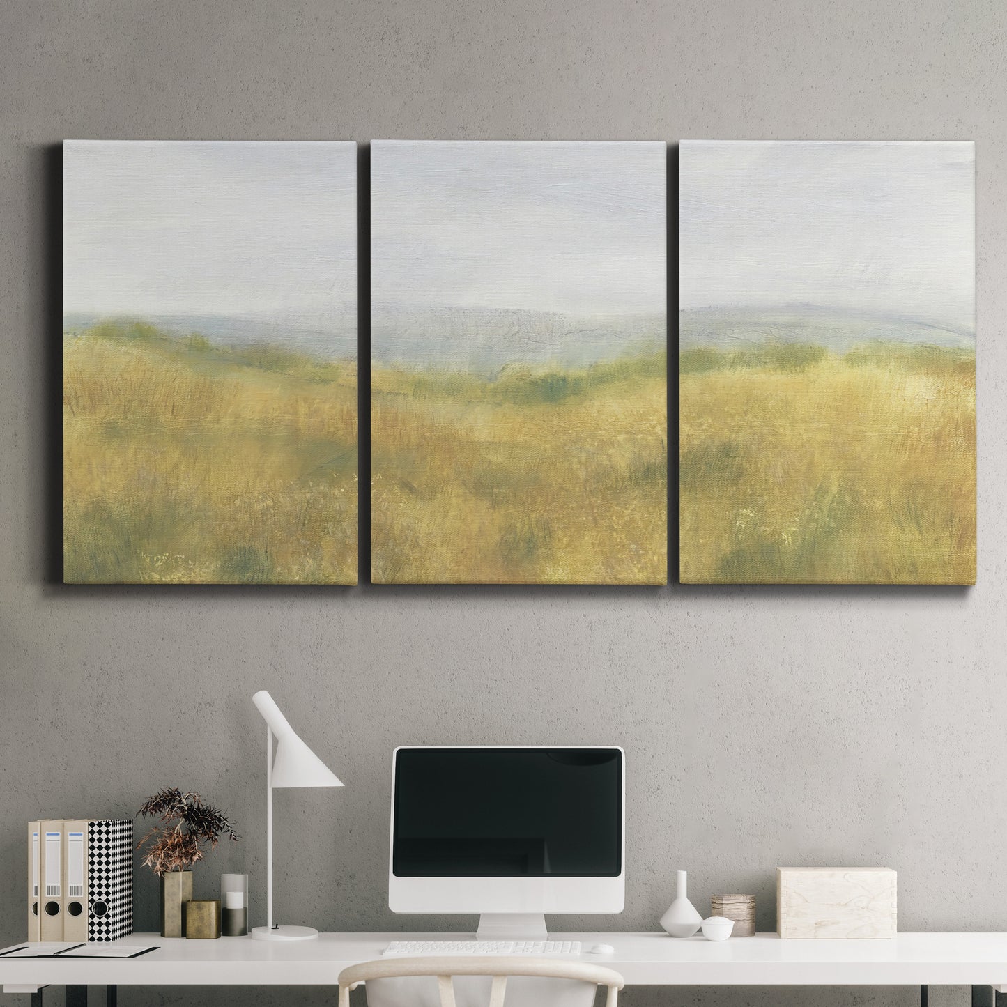 Three-panel canvas wall art featuring pastoral wheat field landscape, displayed above a desk in a home office.