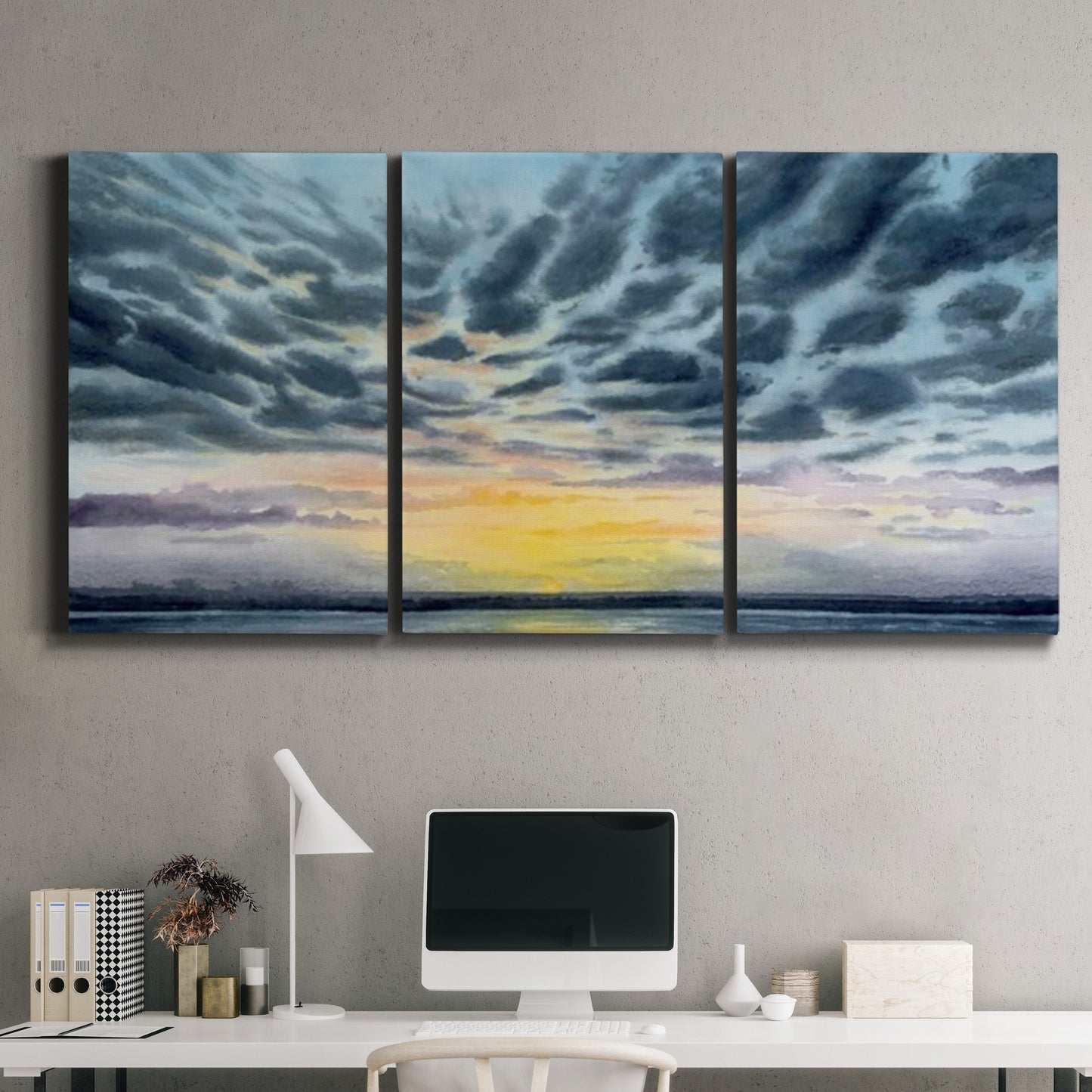 Three-panel canvas wall art featuring tropical coastal sunset over water, displayed above a desk in a home office.
