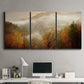 Three-panel canvas wall art featuring misty autumn landscape photograph, displayed above a desk in a home office.