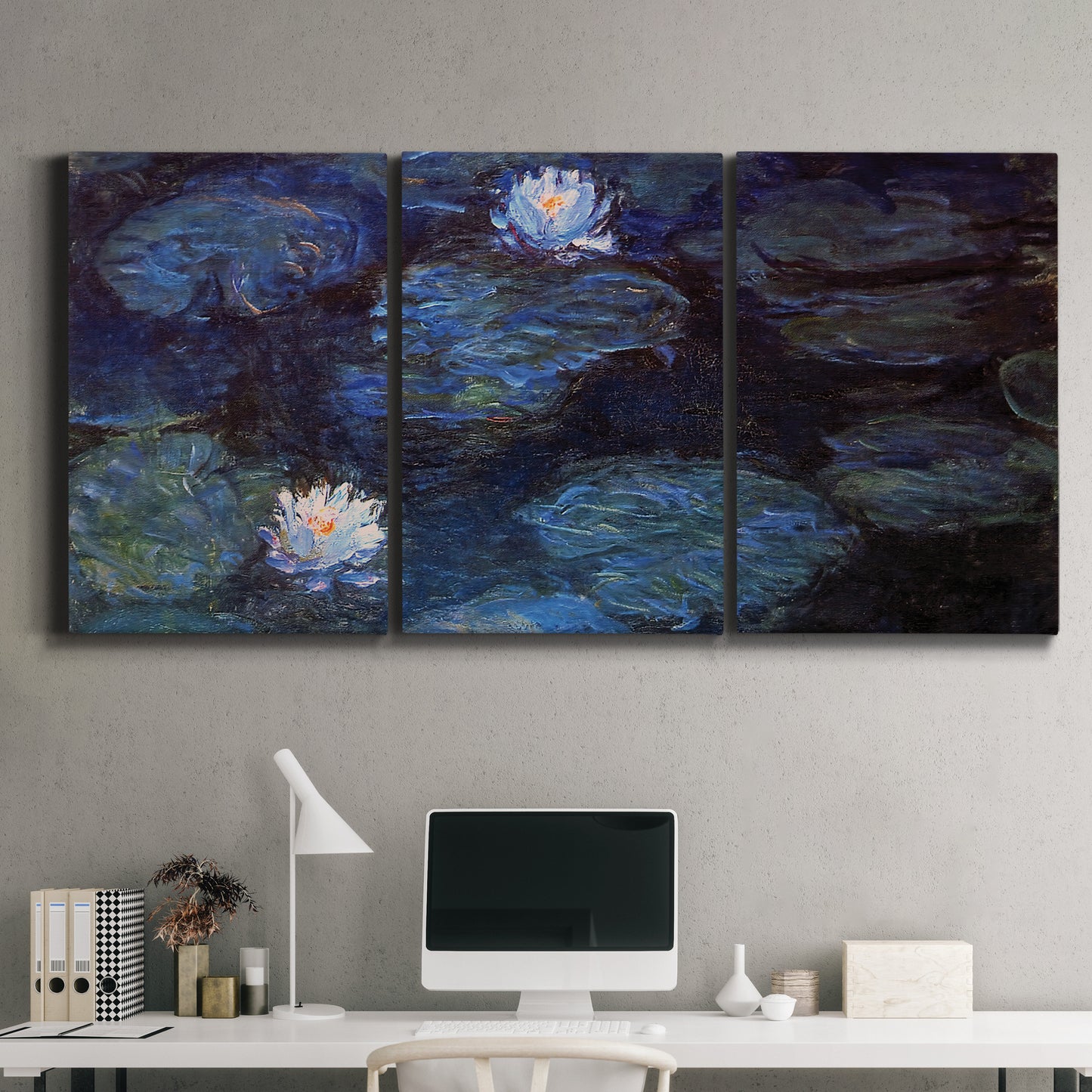 Three-panel canvas wall art featuring deep blue water lily reflections, displayed above a desk in a home office.