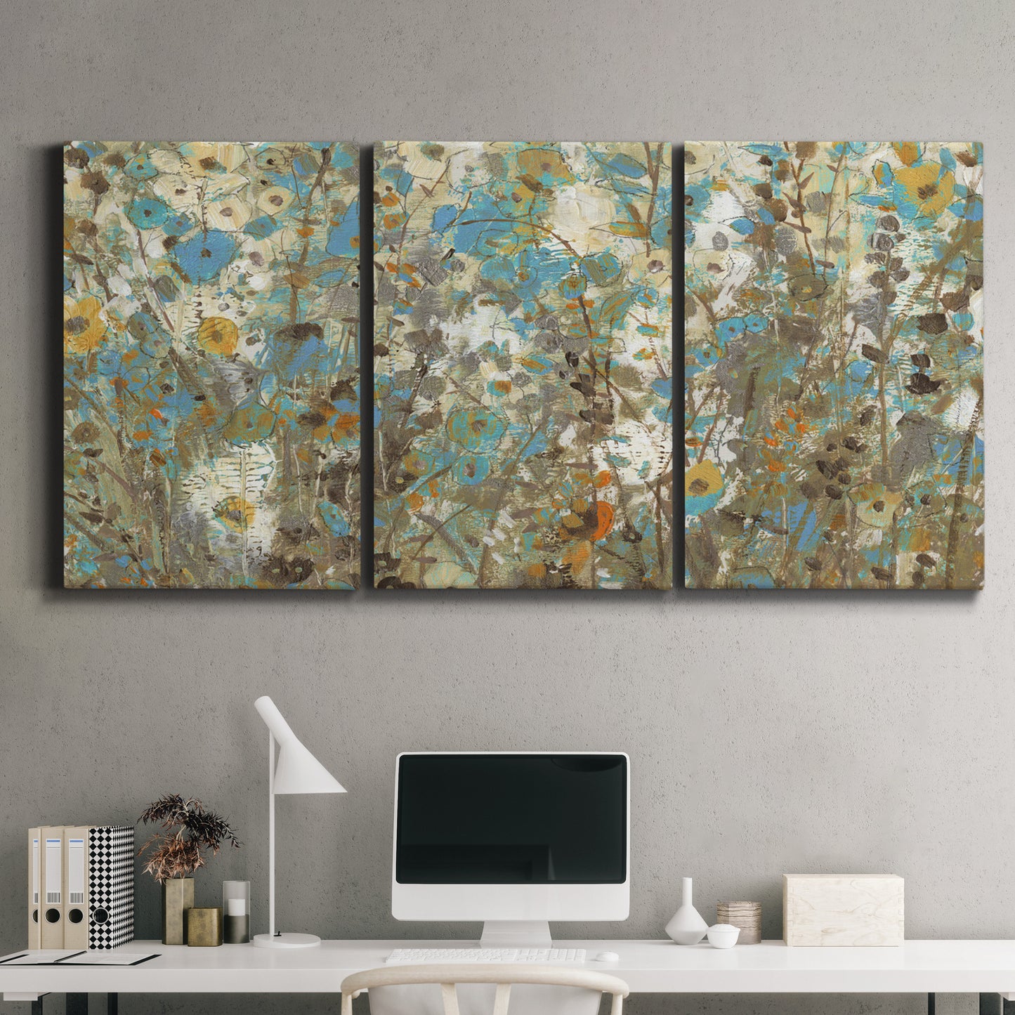Three-panel canvas wall art featuring abstract flowering vine pattern, displayed above a desk in a home office.