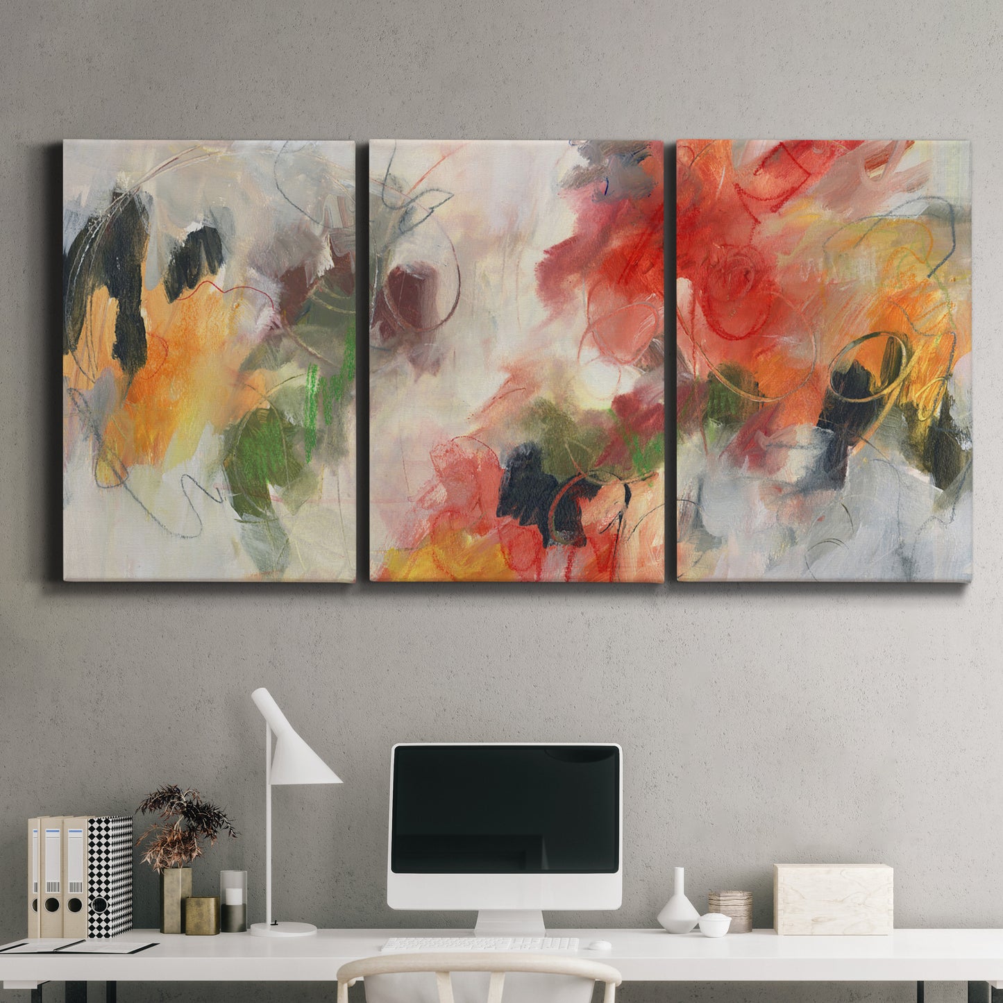 Three-panel canvas wall art featuring abstract floral color composition, displayed above a desk in a home office.