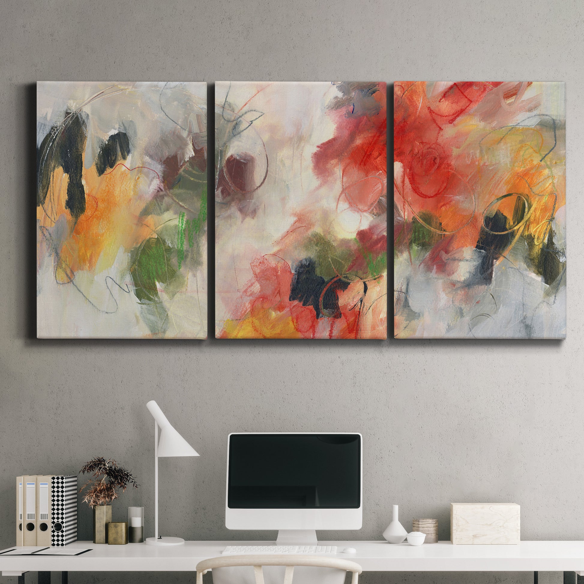 Three-panel canvas wall art featuring abstract floral color composition, displayed above a desk in a home office.