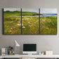 Three-panel canvas wall art featuring rugged coastal cliff landscape, displayed above a desk in a home office.