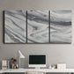 Three-panel canvas wall art featuring minimal monochrome abstract forms, displayed above a desk in a home office.