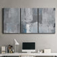 Three-panel canvas wall art featuring cool toned industrial abstract blues, displayed above a desk in a home office.