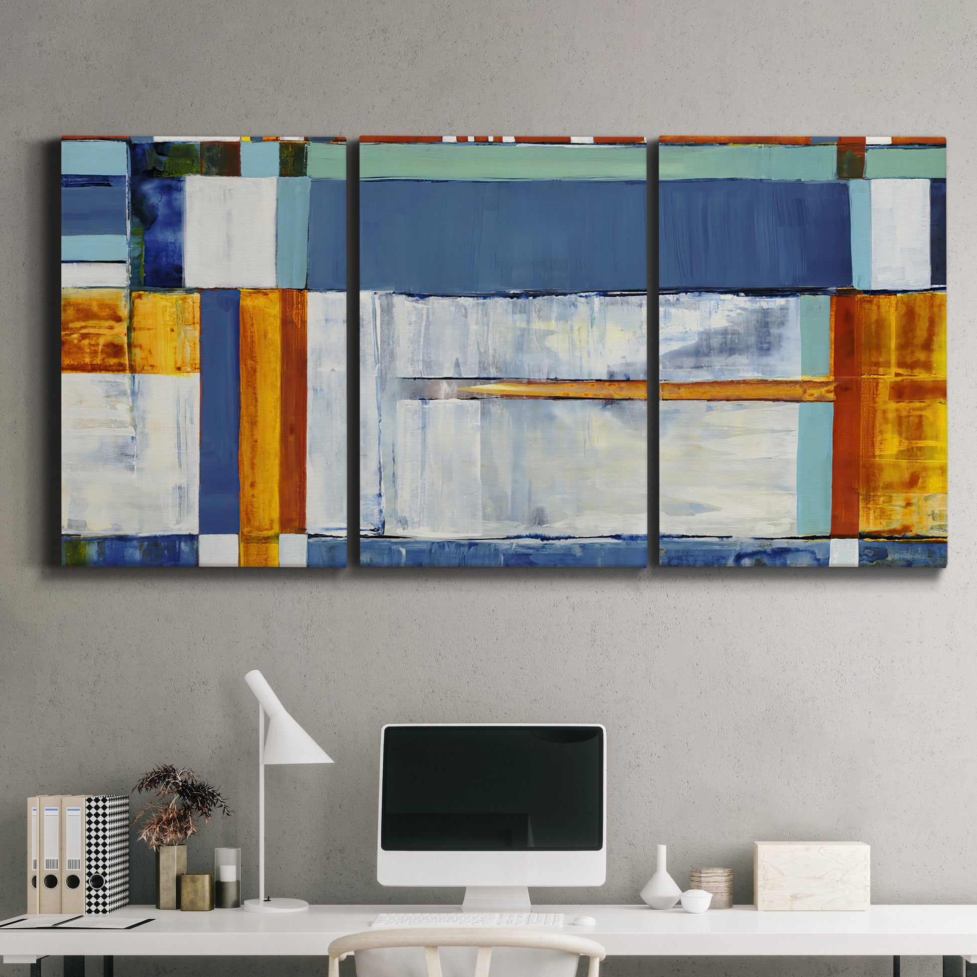 Three-panel canvas wall art featuring bright mid century geometric abstraction, displayed above a desk in a home office.