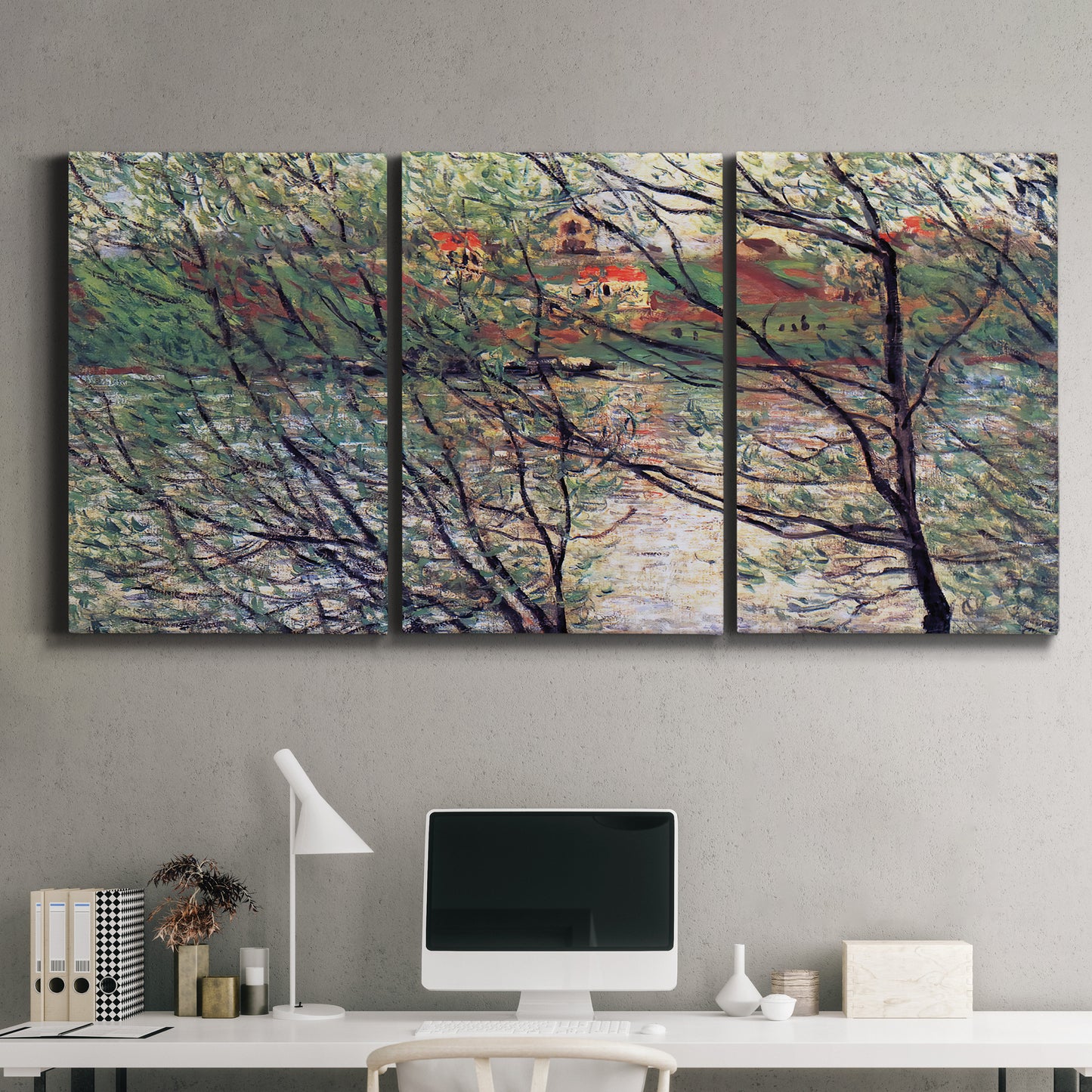 Three-panel canvas wall art featuring riverside park with figures and trees, displayed above a desk in a home office.