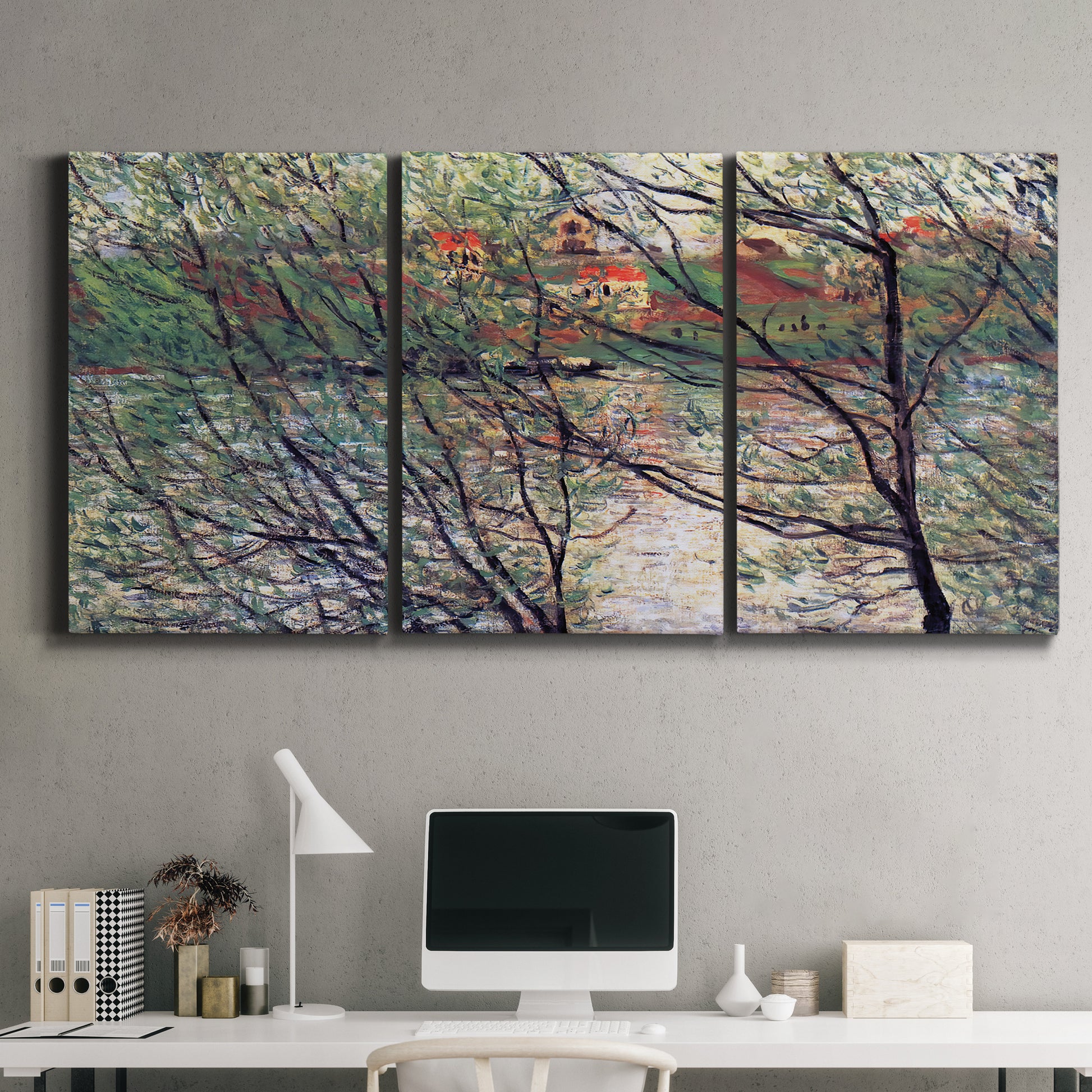 Three-panel canvas wall art featuring riverside park with figures and trees, displayed above a desk in a home office.