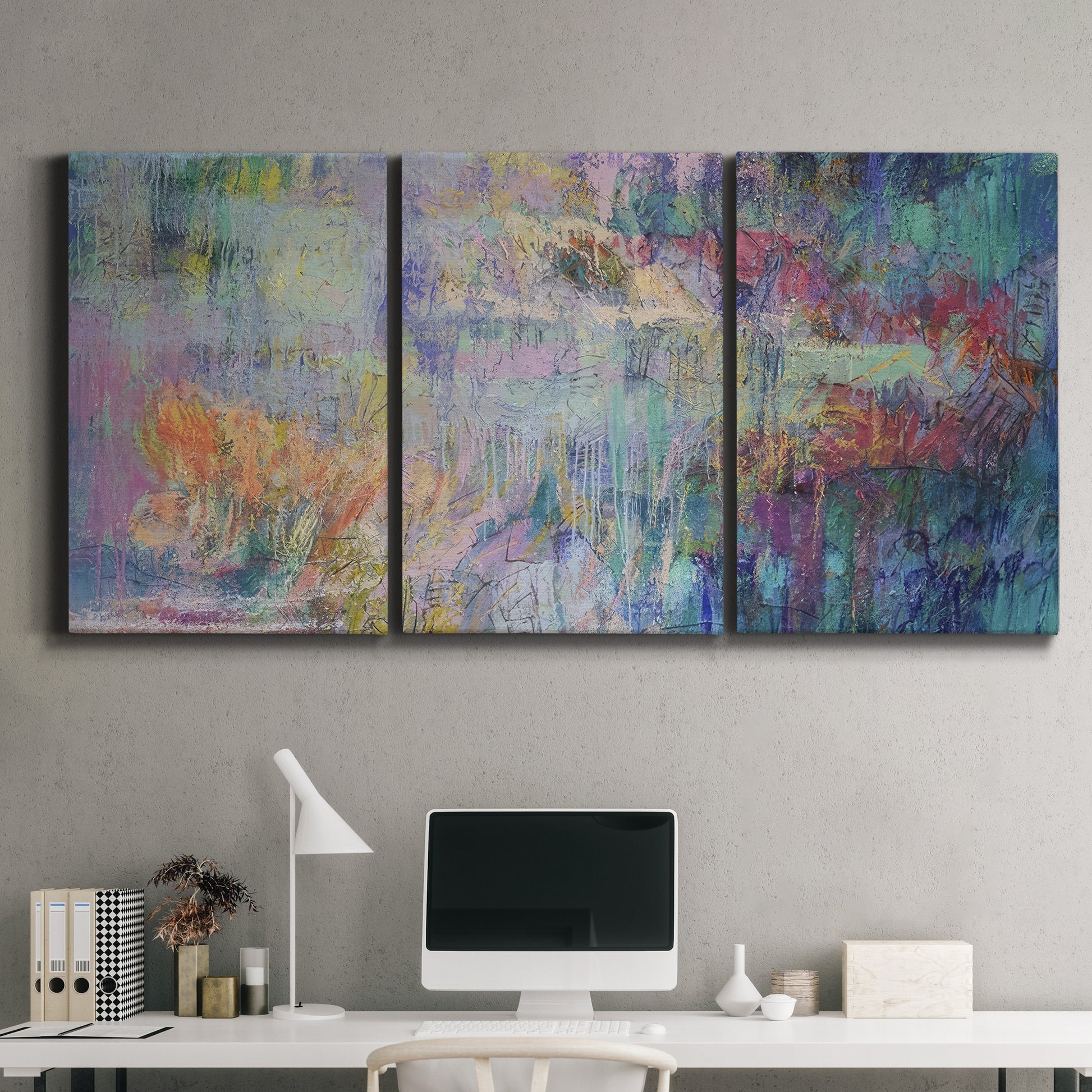Three-panel canvas wall art featuring abstract evening landscape with depth, displayed above a desk in a home office.