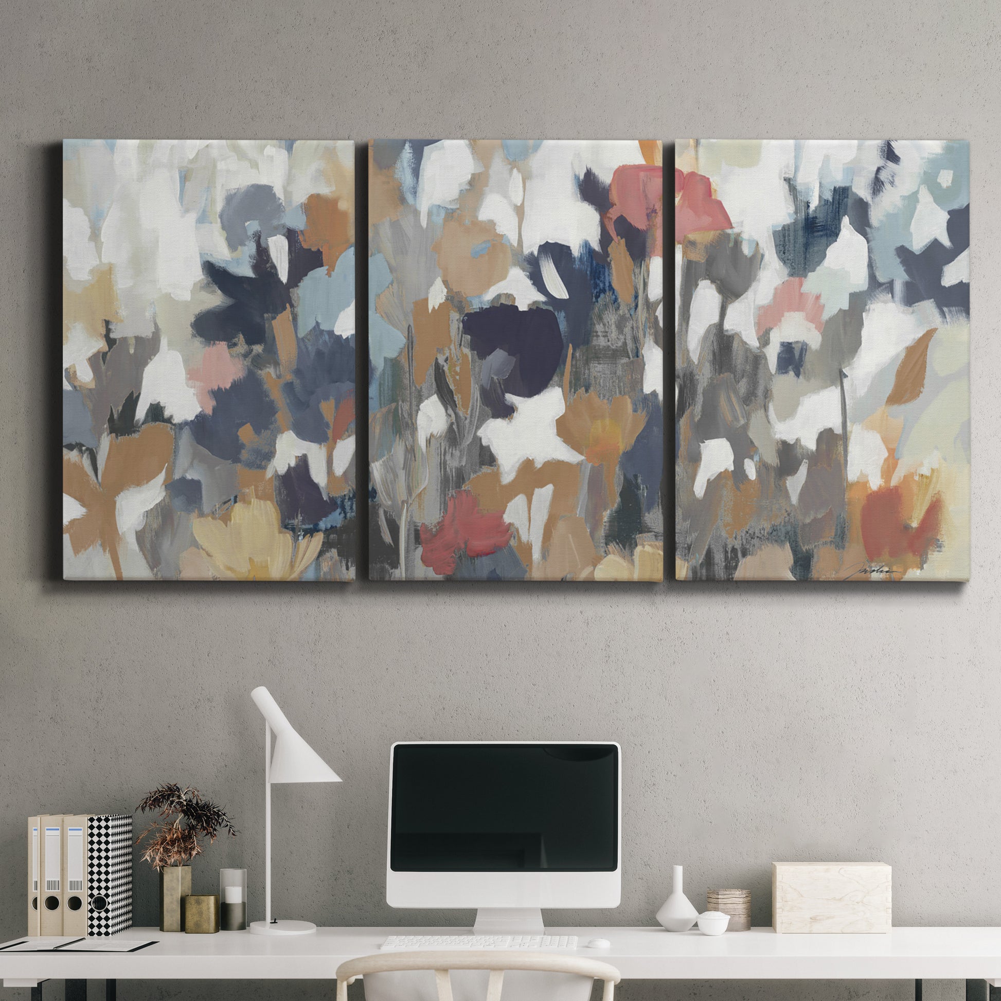 Three-panel canvas wall art featuring abstract flower stand composition, displayed above a desk in a home office.