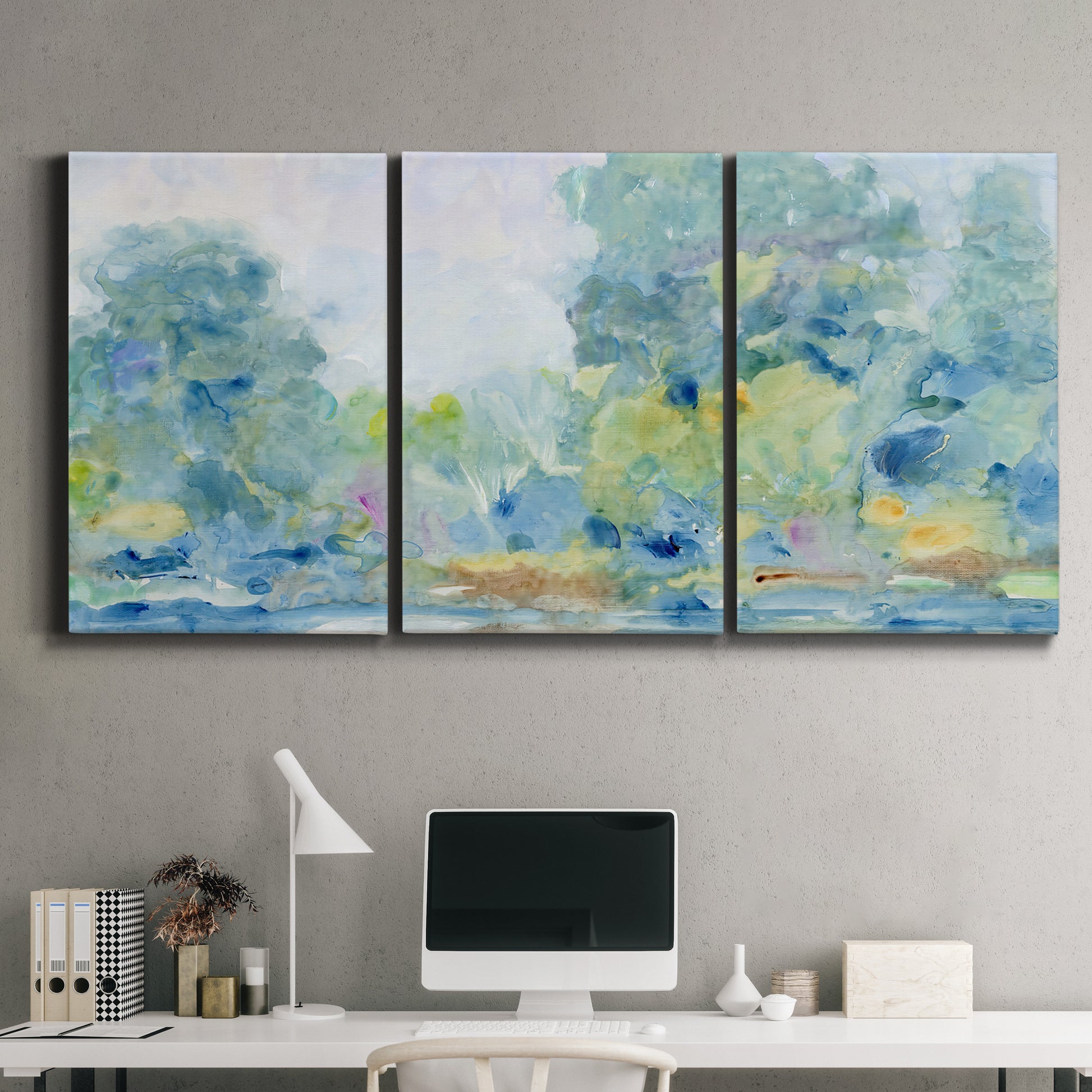 Three-panel canvas wall art featuring quiet abstract morning landscape, displayed above a desk in a home office.