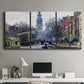 Three-panel canvas wall art featuring historic tower beside canal, displayed above a desk in a home office.