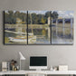 Three-panel canvas wall art featuring bridge crossing broad river, displayed above a desk in a home office.
