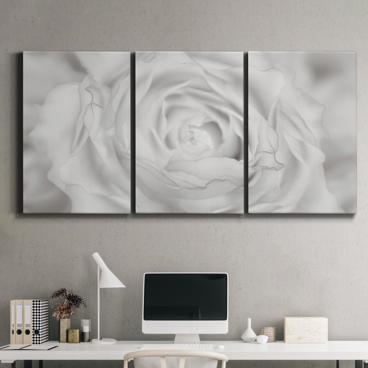 Three-panel canvas wall art featuring monochrome rose study photograph, displayed above a desk in a home office.