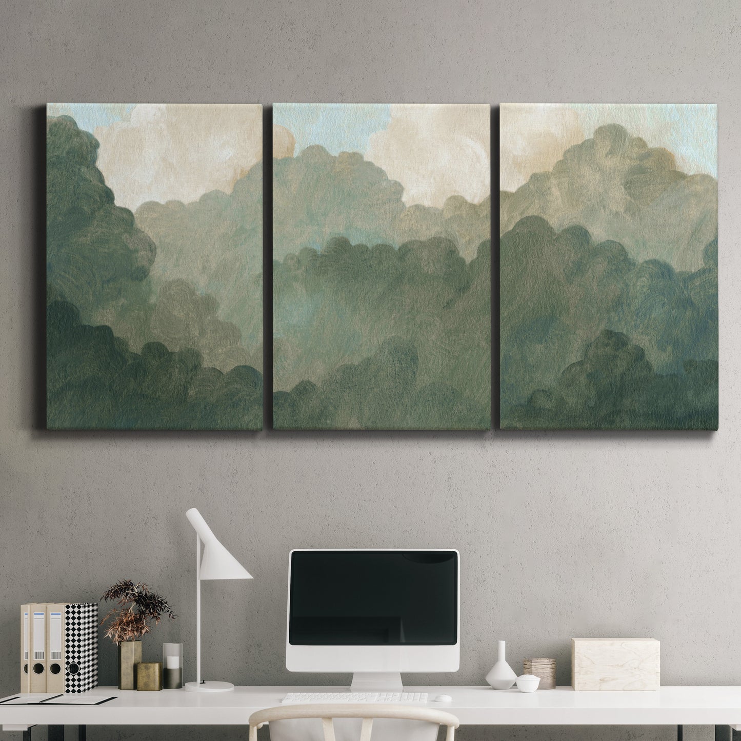 Three-panel canvas wall art featuring autumn storm over rolling landscape, displayed above a desk in a home office.