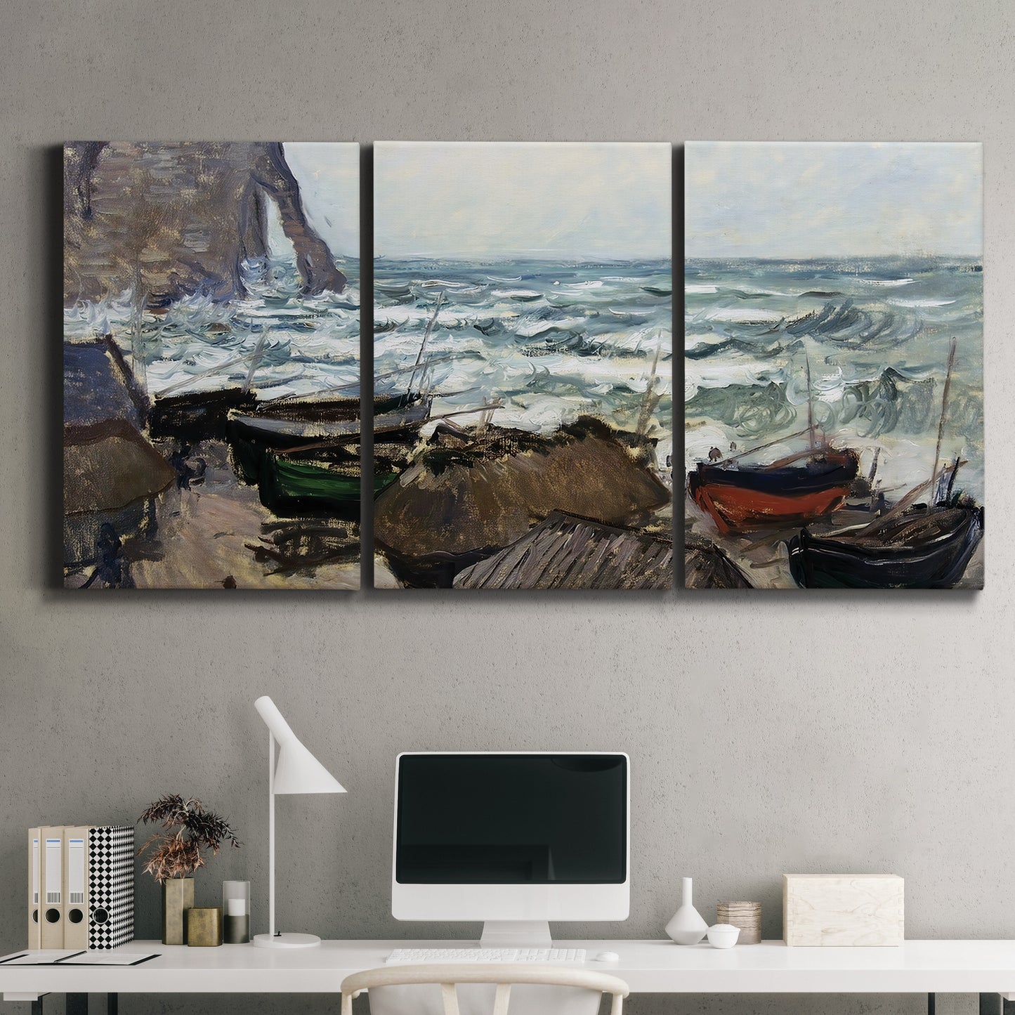 Three-panel canvas wall art featuring rough coastal seas under storm clouds, displayed above a desk in a home office.
