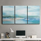 Three-panel canvas wall art featuring sunset silhouette over coastal water, displayed above a desk in a home office.