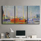 Three-panel canvas wall art featuring red boats along riverbank, displayed above a desk in a home office.