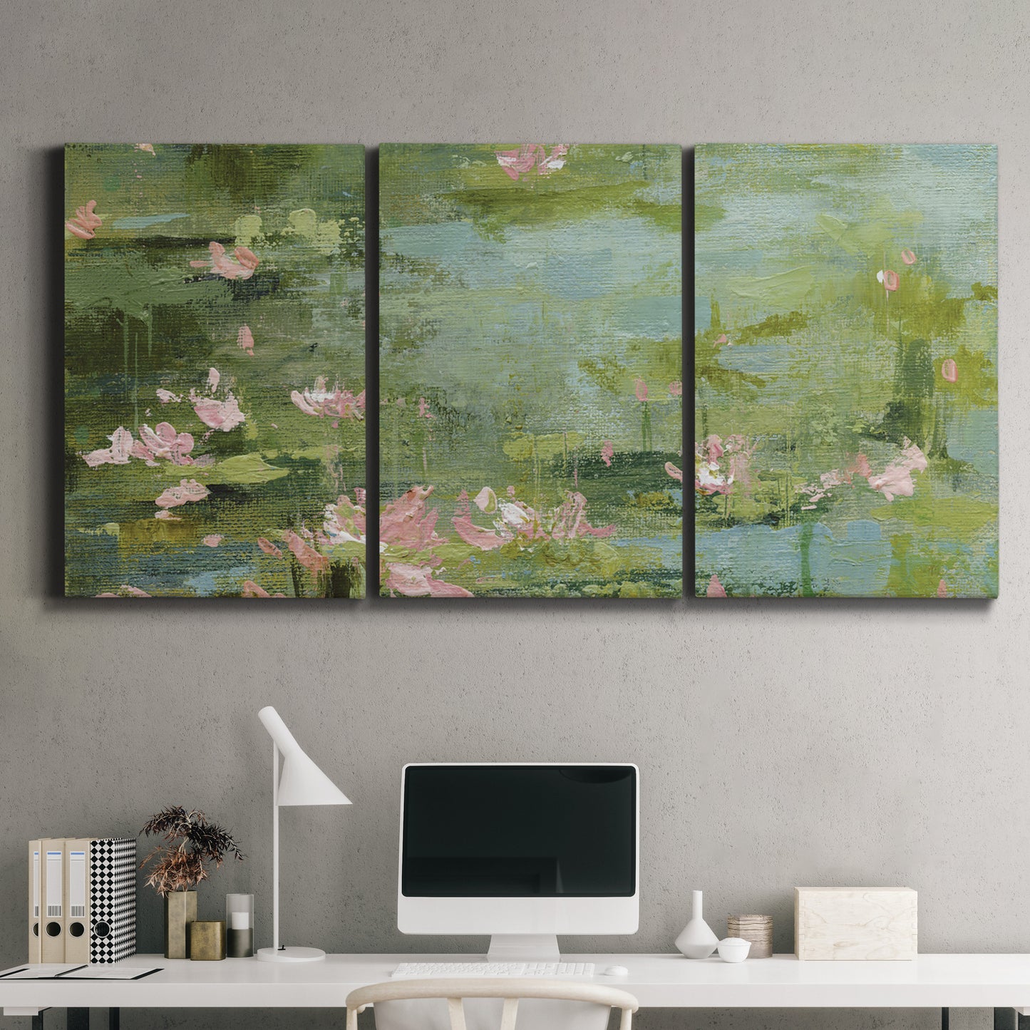 Three-panel canvas wall art featuring muted water lily pond, displayed above a desk in a home office.