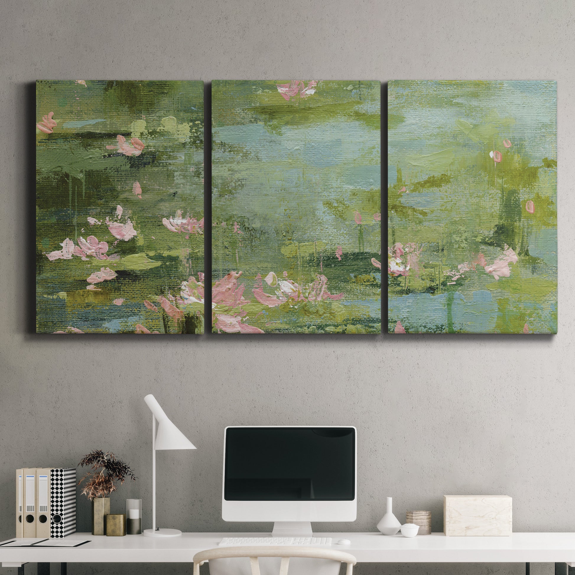 Three-panel canvas wall art featuring muted water lily pond, displayed above a desk in a home office.