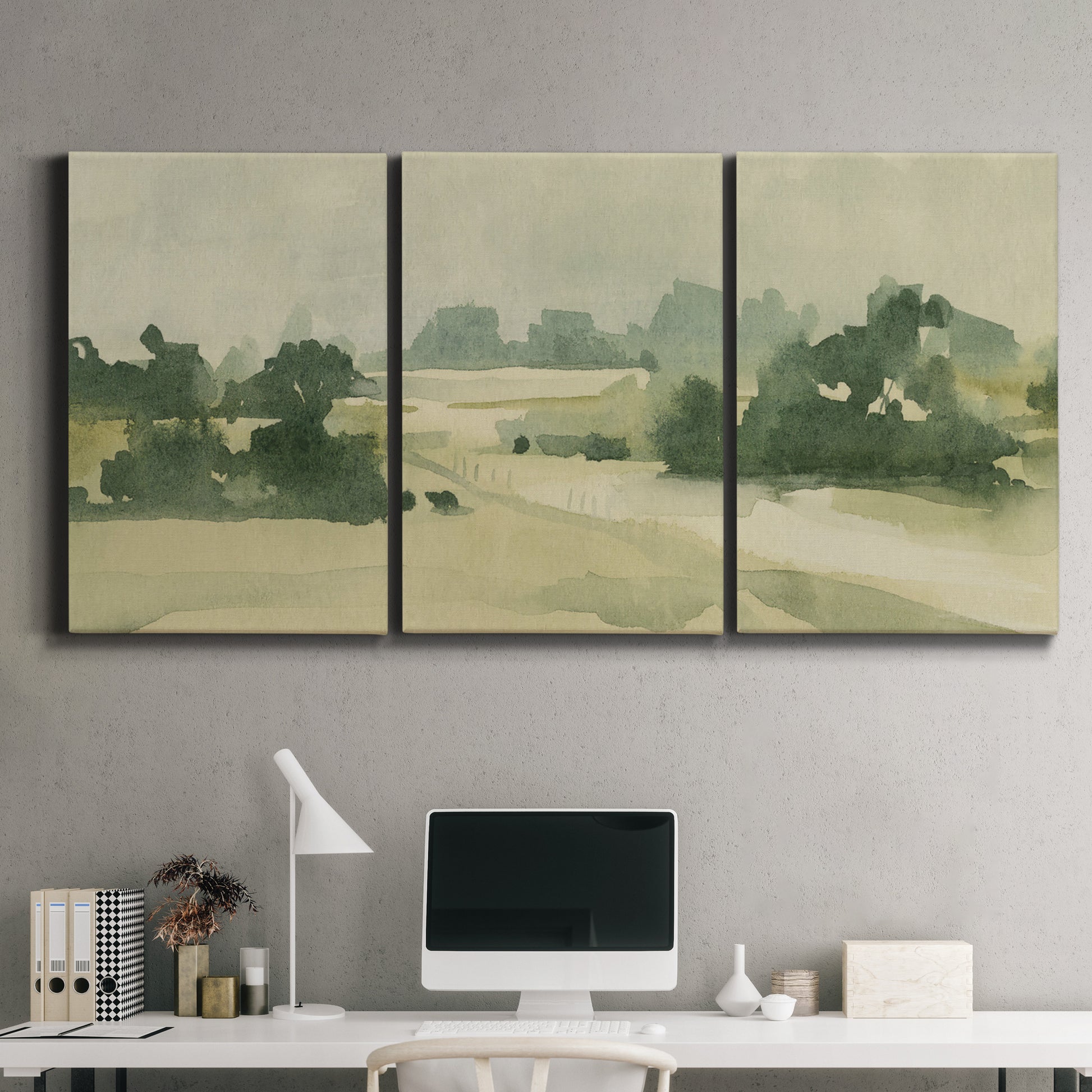 Three-panel canvas wall art featuring pasture landscape in soft watercolor, displayed above a desk in a home office.