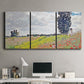 Three-panel canvas wall art featuring open poppy field in countryside, displayed above a desk in a home office.