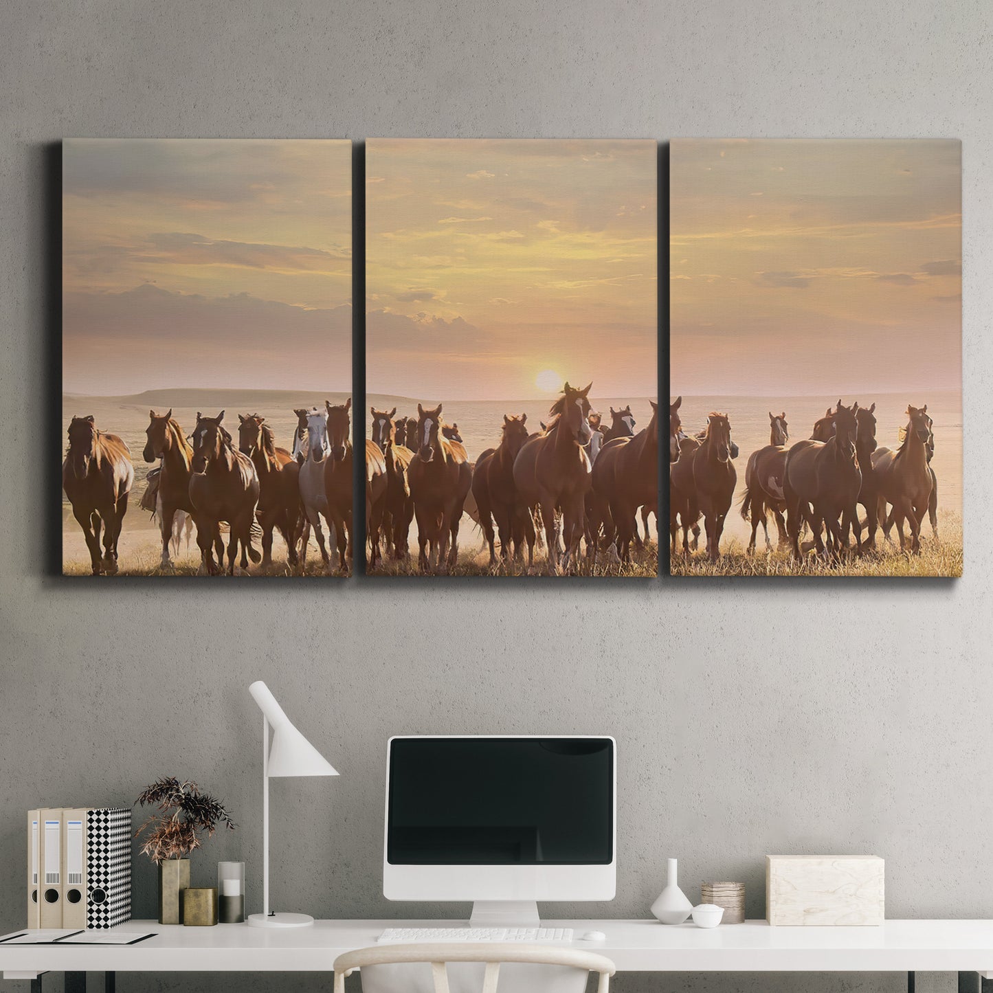 Three-panel canvas wall art featuring running horses captured in motion, displayed above a desk in a home office.