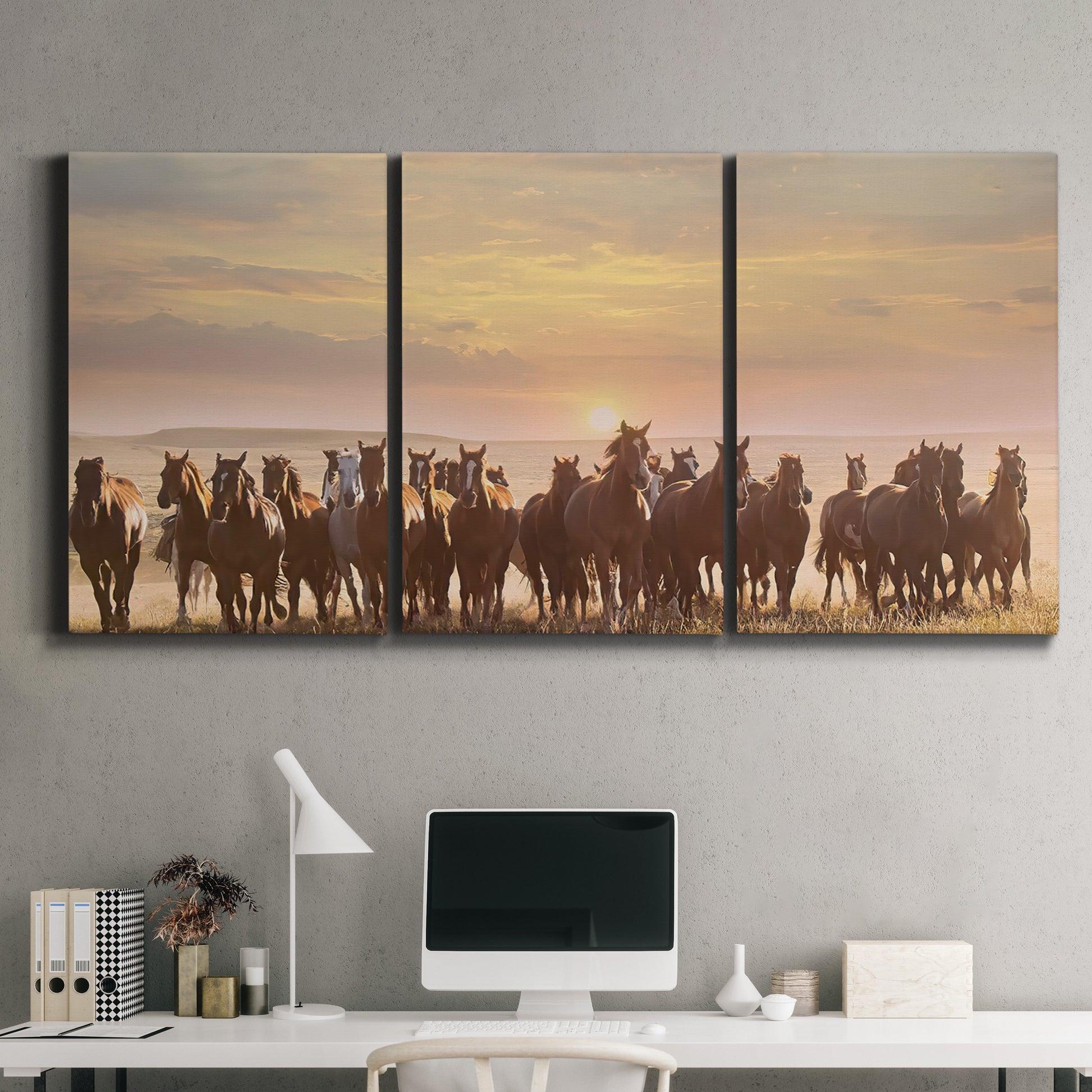 Three-panel canvas wall art featuring running horses captured in motion, displayed above a desk in a home office.