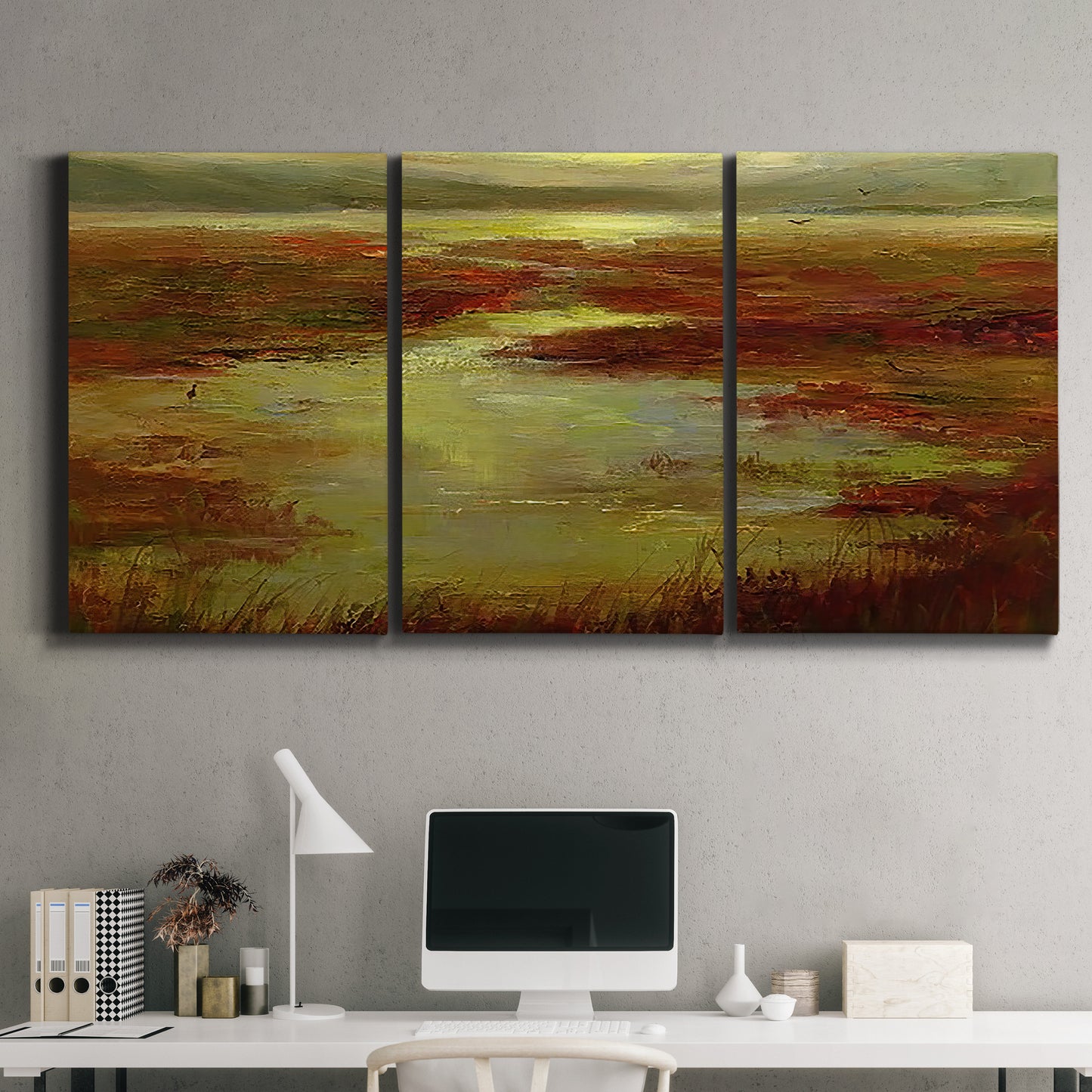 Three-panel canvas wall art featuring coastal shoreline with warm light, displayed above a desk in a home office.