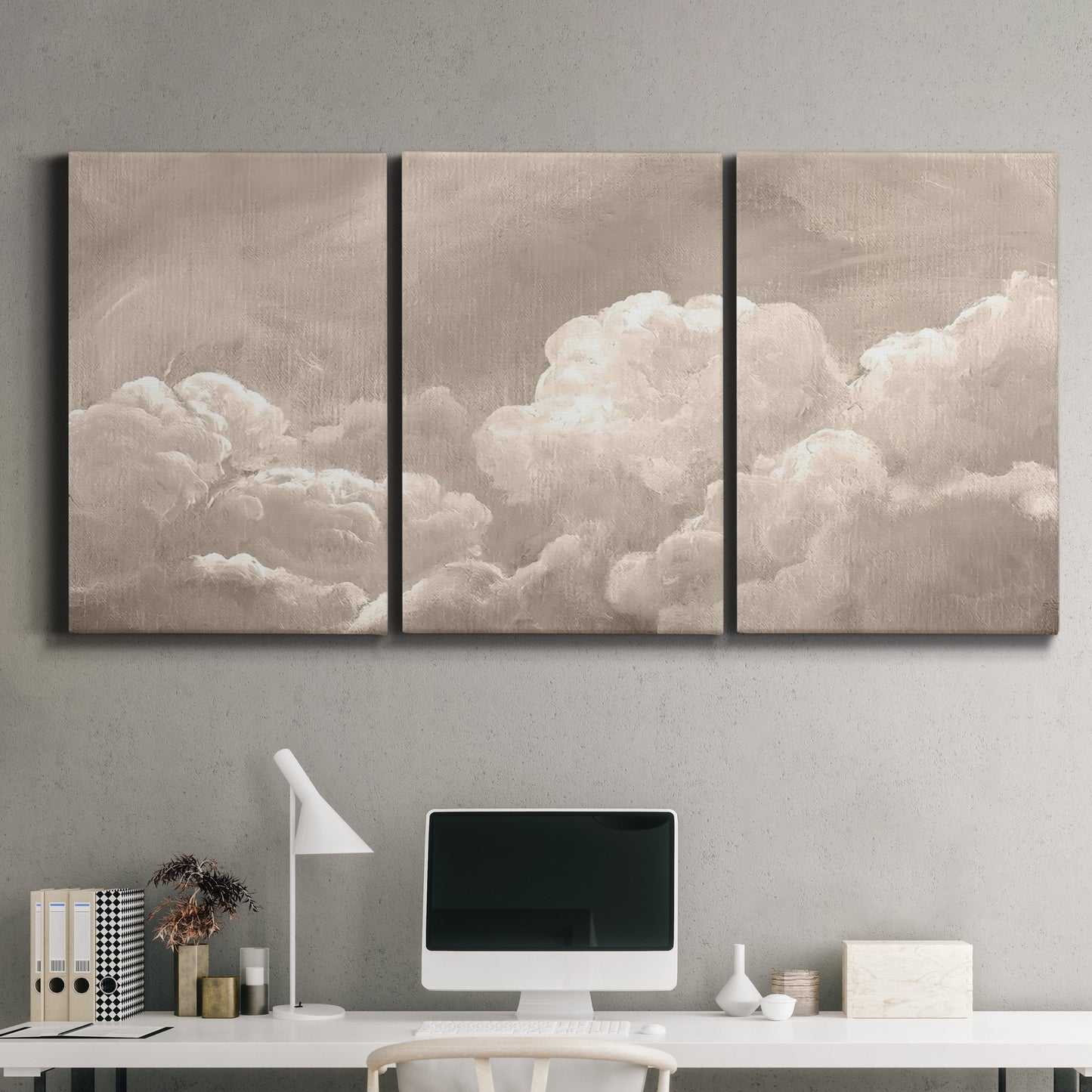 Three-panel canvas wall art featuring soft whimsical cloudscape, displayed above a desk in a home office.