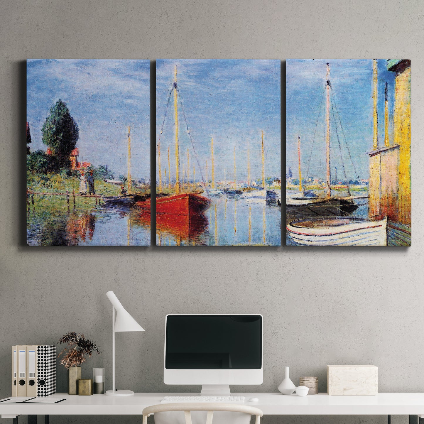 Three-panel canvas wall art featuring sailboats gathered along river, displayed above a desk in a home office.