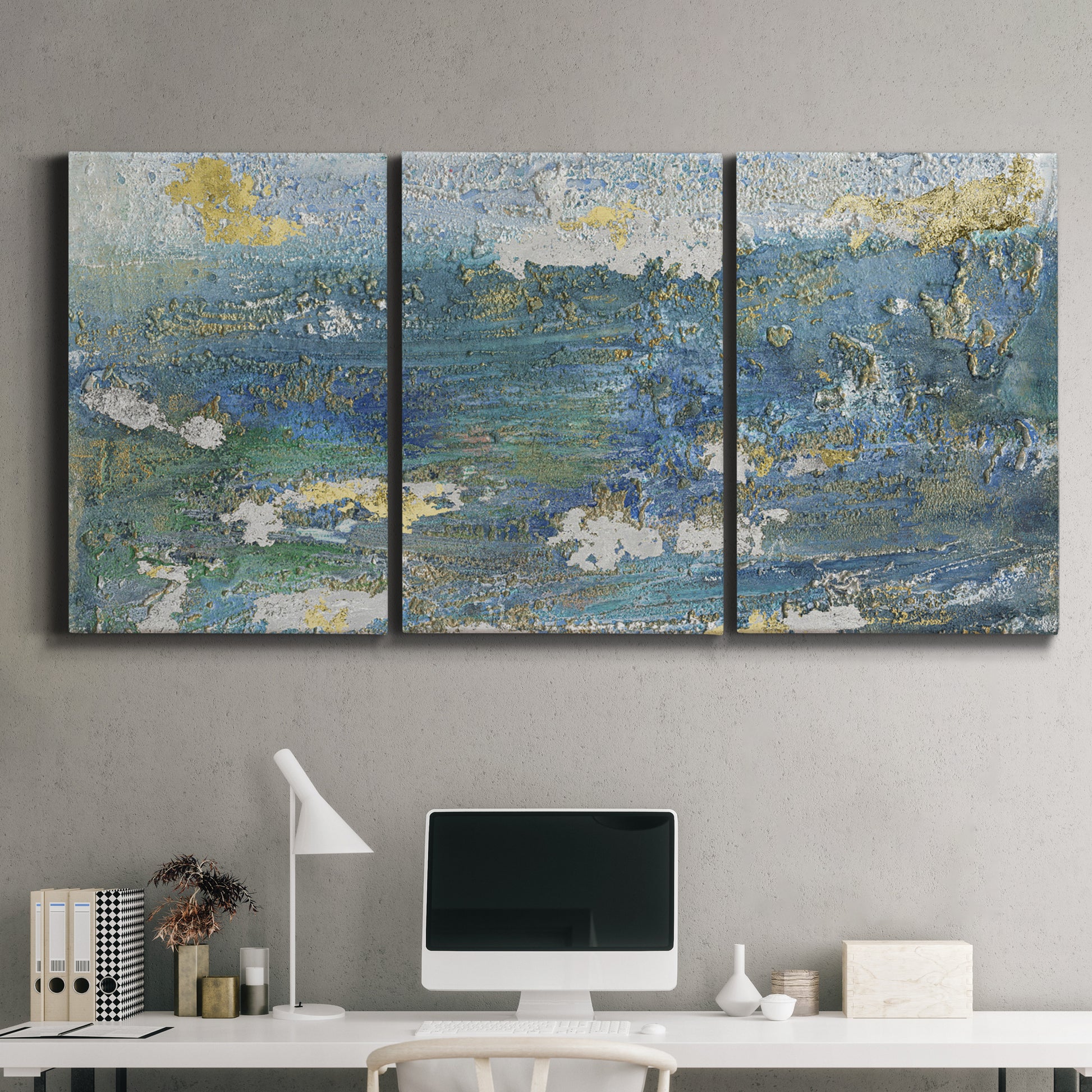 Three-panel canvas wall art featuring sparkling abstract sea surface, displayed above a desk in a home office.