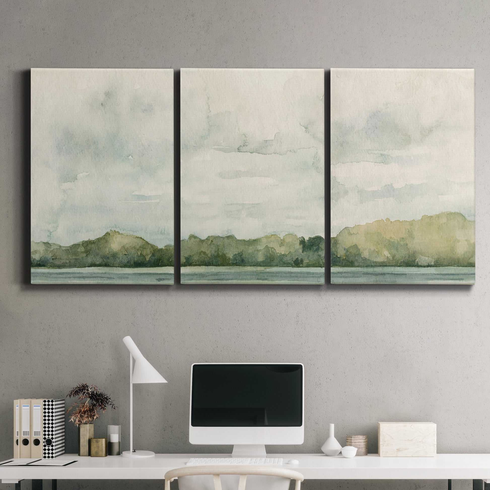 Three-panel canvas wall art featuring riverbank landscape with trees, displayed above a desk in a home office.