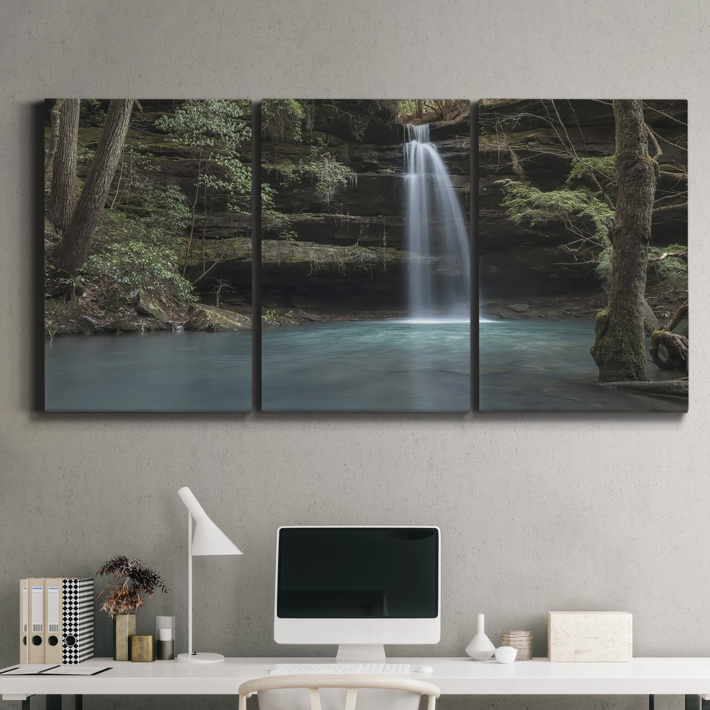Three-panel canvas wall art featuring waterfall cascading through forest, displayed above a desk in a home office.