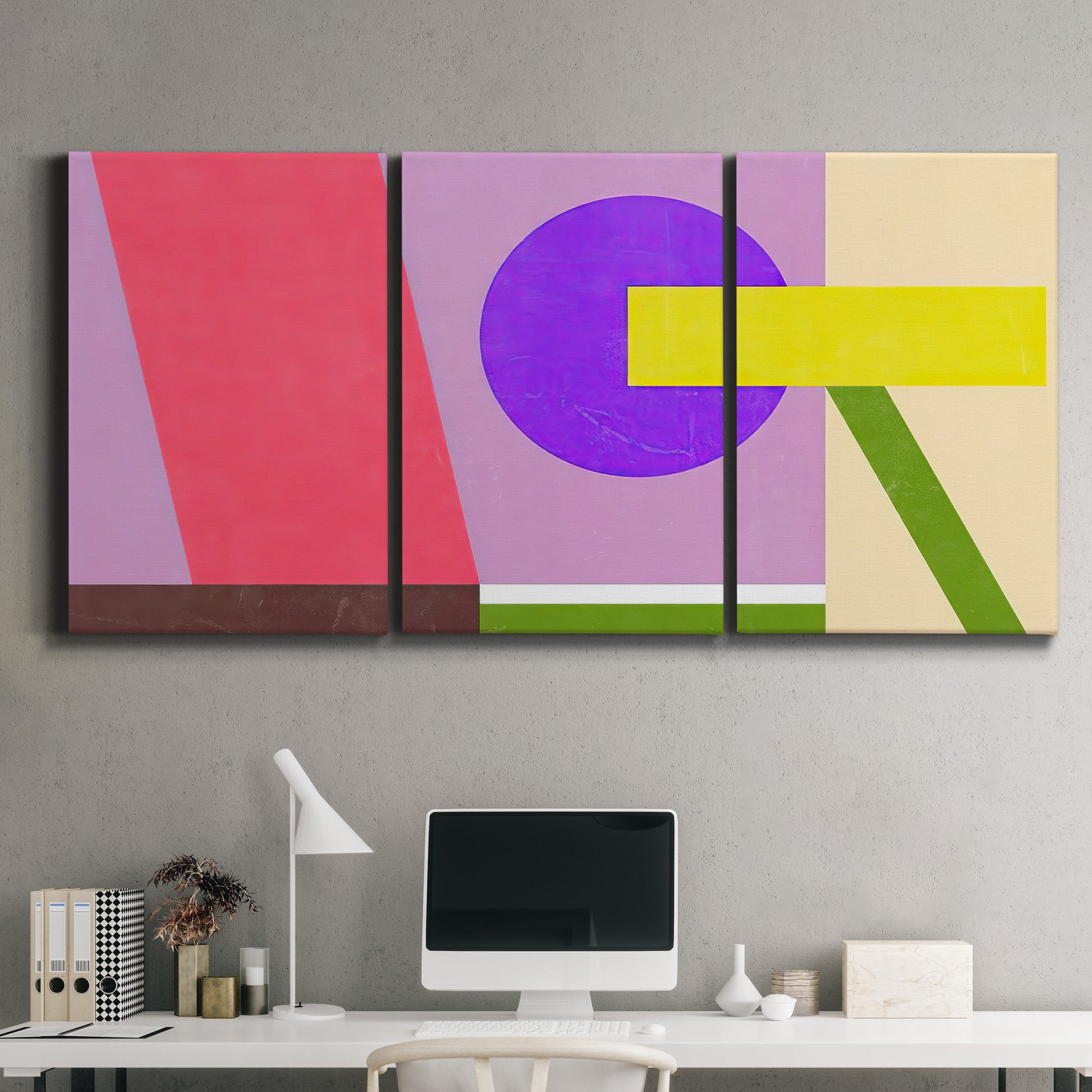 Three-panel canvas wall art featuring bold geometric color abstraction, displayed above a desk in a home office.