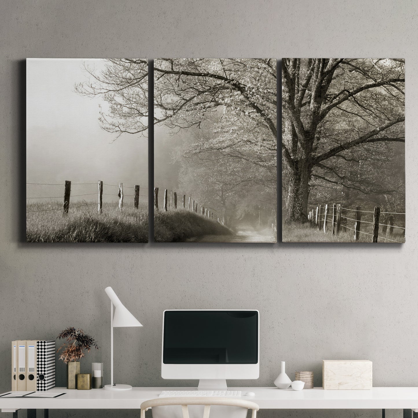 Three-panel canvas wall art featuring fenced rural path through countryside, displayed above a desk in a home office.