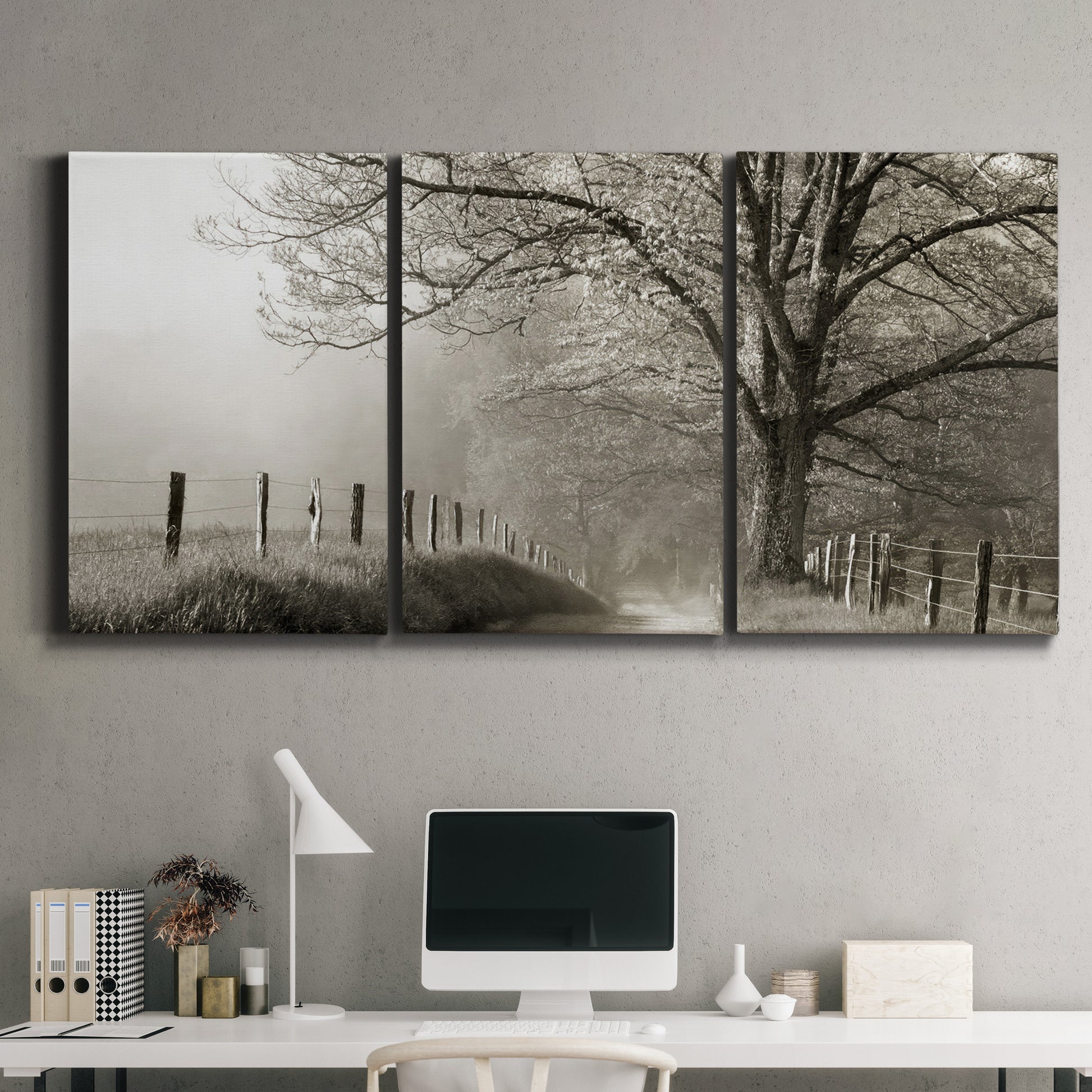 Three-panel canvas wall art featuring fenced rural path through countryside, displayed above a desk in a home office.