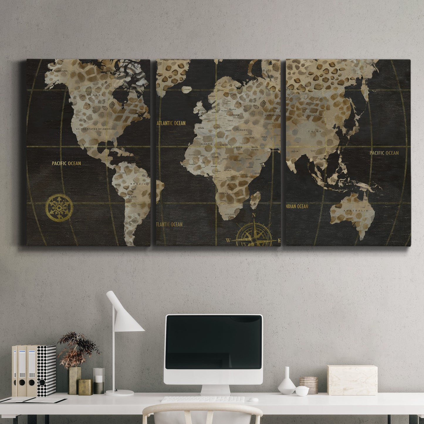 Three-panel canvas wall art featuring illustrated safari world map, displayed above a desk in a home office.
