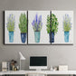 Three-panel canvas wall art featuring minimal monochrome abstract forms, displayed above a desk in a home office.