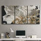 Three-panel canvas wall art featuring pale abstract mask like forms, displayed above a desk in a home office.