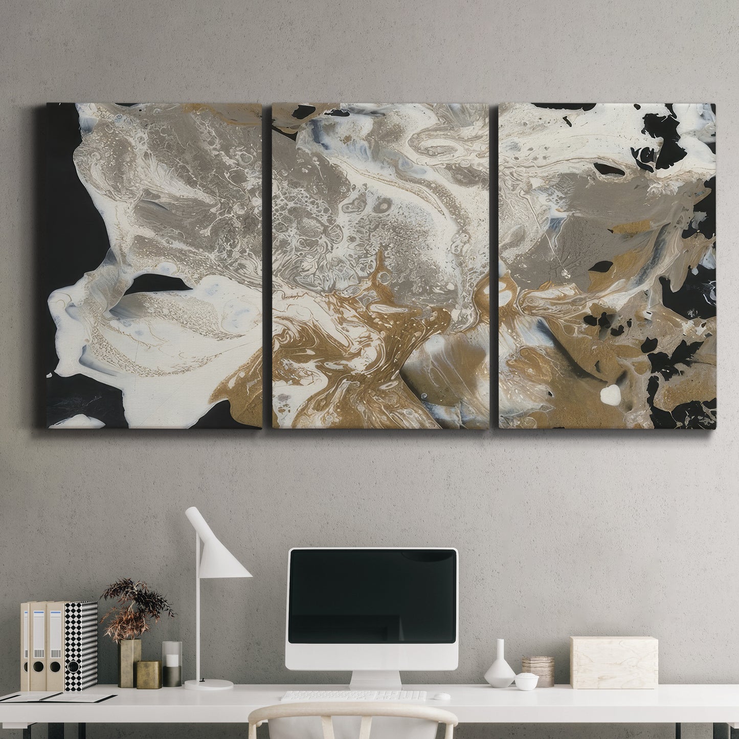 Three-panel canvas wall art featuring pale abstract mask like forms, displayed above a desk in a home office.