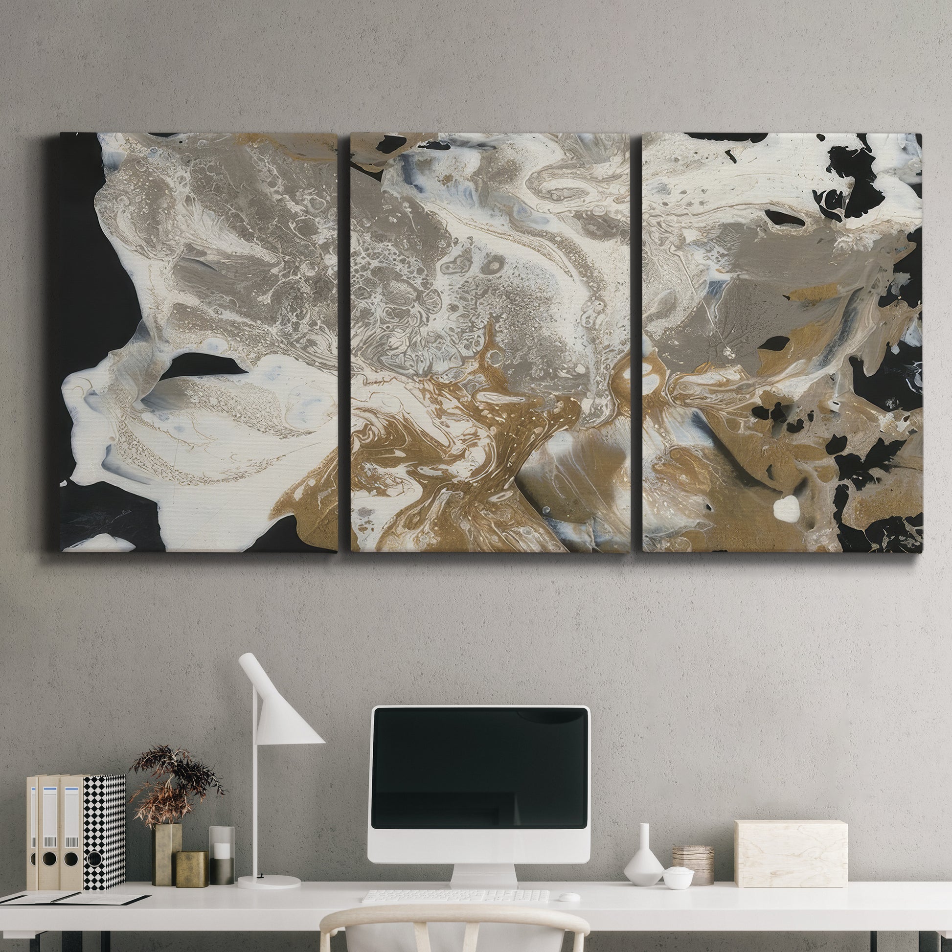 Three-panel canvas wall art featuring pale abstract mask like forms, displayed above a desk in a home office.