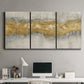 Three-panel canvas wall art featuring flowing abstract golden tones, displayed above a desk in a home office.
