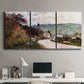 Three-panel canvas wall art featuring country road through village, displayed above a desk in a home office.